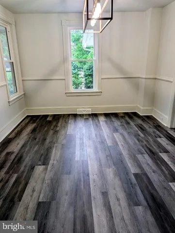 a view of a room with wooden floor