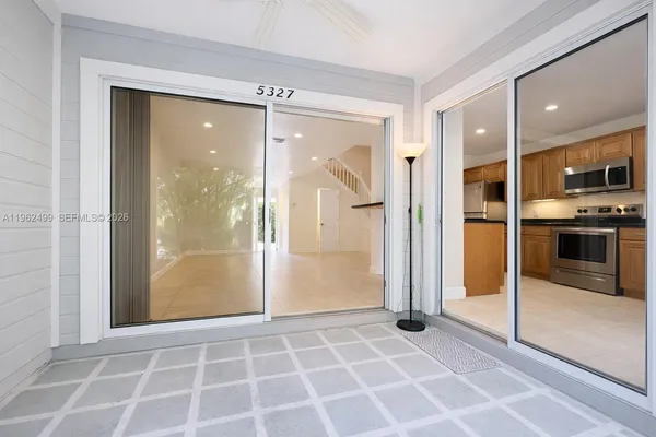 a view of a kitchen with a sink and a refrigerator