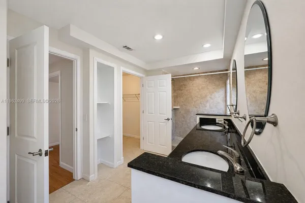 a bathroom with a sink and mirror