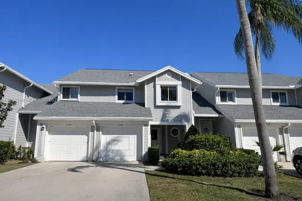 a view of a swimming pool with a lounge chair and floor to ceiling window