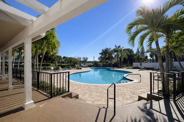 a view of a swimming pool and lounge chairs