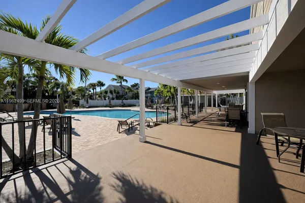 a view of swimming pool with outdoor seating and yard in back