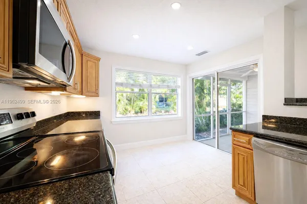 a kitchen with a stove a sink and a microwave