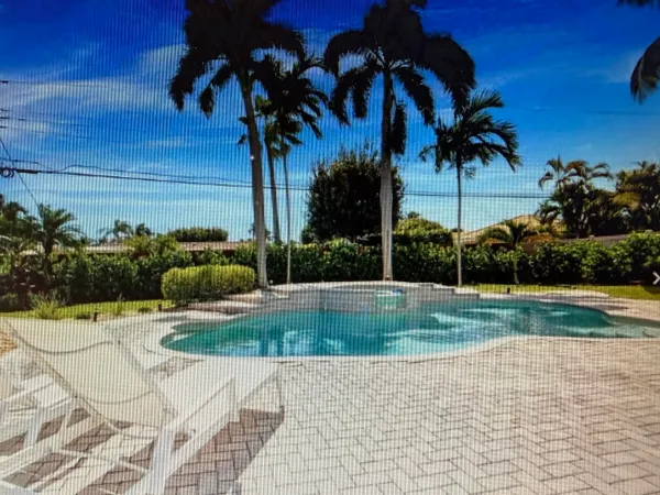 a view of a swimming pool with a yard