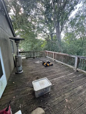 a view of a wooden deck with chairs