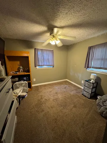 a bedroom with bed and a chandelier