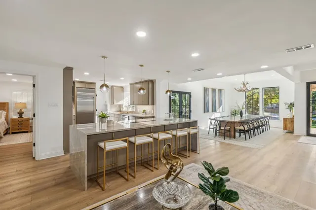 a very nice looking dining room with furniture and wooden floor