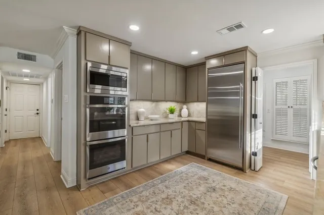 a kitchen with granite countertop a refrigerator and a sink