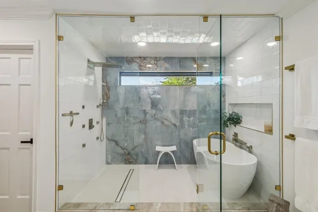 a bathroom with a bathtub and shower