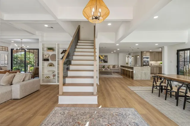 a view of a patio with table and chairs under an umbrella
