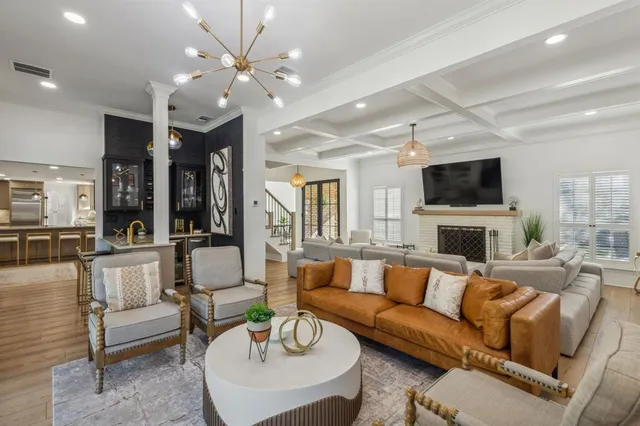 a living room with fireplace furniture and a flat screen tv