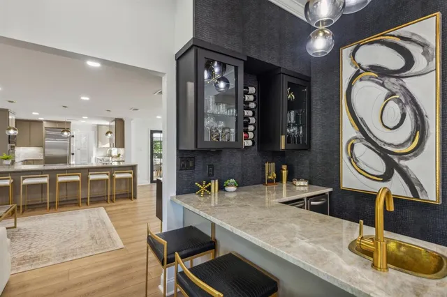 a kitchen with granite countertop a sink a stove and cabinets