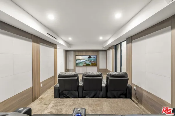 a living room with furniture a flat screen tv and a window