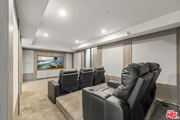 a living room with furniture a projector and a flat screen tv