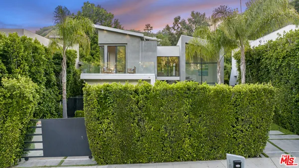 a view of a house with a yard and plants