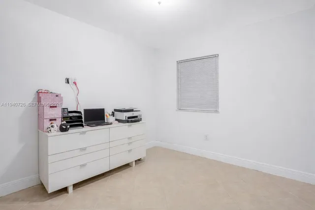 a room with a bed and dresser