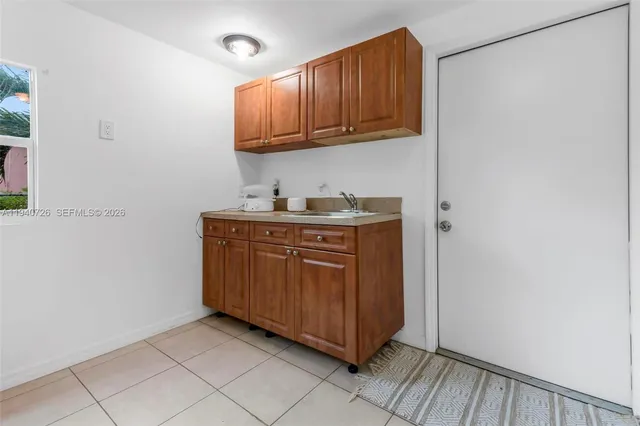a kitchen with a sink a cabinets and window