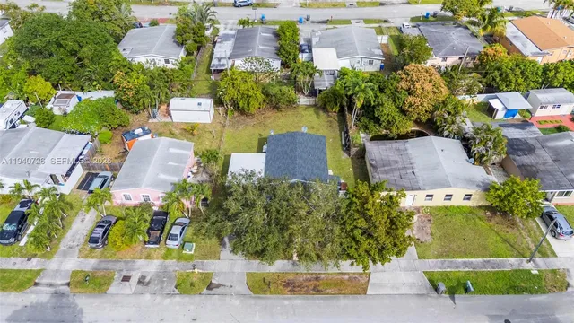 an aerial view of multiple houses with yard