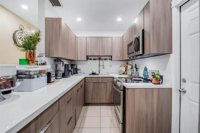 a kitchen with a sink cabinets and window
