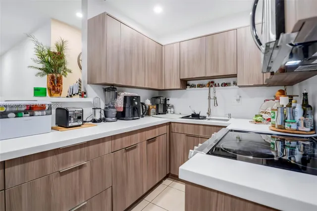 a kitchen with cabinets a sink and white appliances