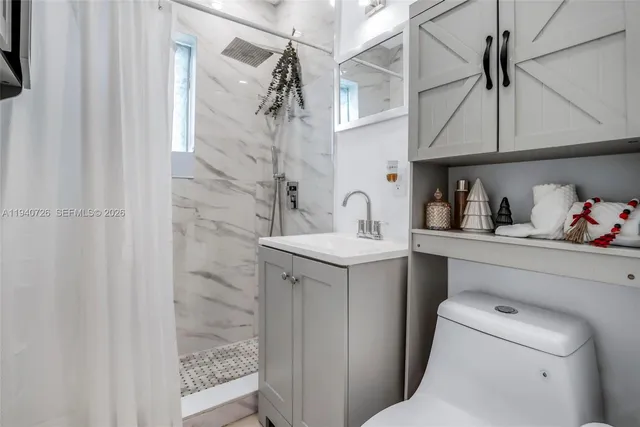 a bathroom with a sink toilet and shower