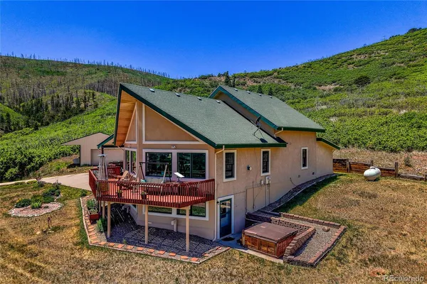 a view of house with backyard porch and outdoor seating