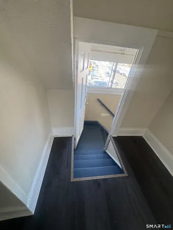 a view of entryway and hall with wooden floor