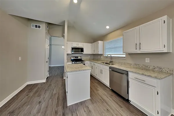 a kitchen with wooden cabinets and white appliances