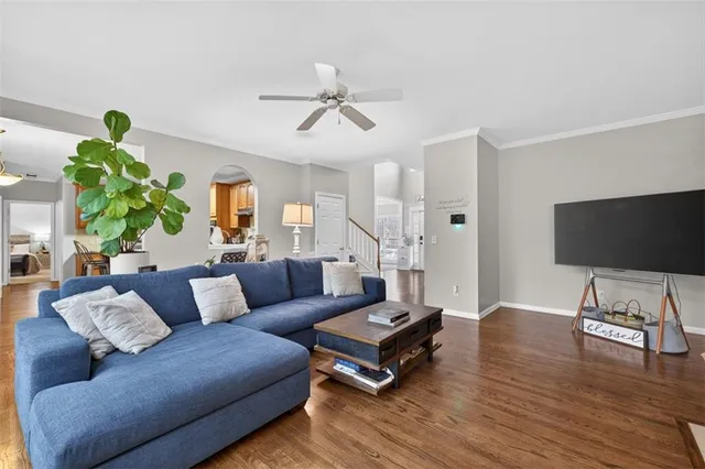 a kitchen with stainless steel appliances granite countertop a refrigerator a stove top oven and a wooden floors