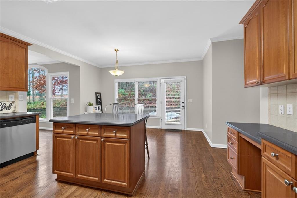 2641 Hillgrove Drive Dacula, GA 30019 - Photo 20 of 57 a kitchen with granite countertop a sink cabinets and wooden floor