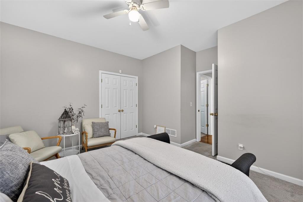 2641 Hillgrove Drive Dacula, GA 30019 - Photo 22 of 57 a bedroom with a bed and a chandelier