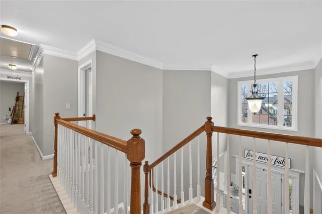 a spacious bedroom with a large bed and a chandelier