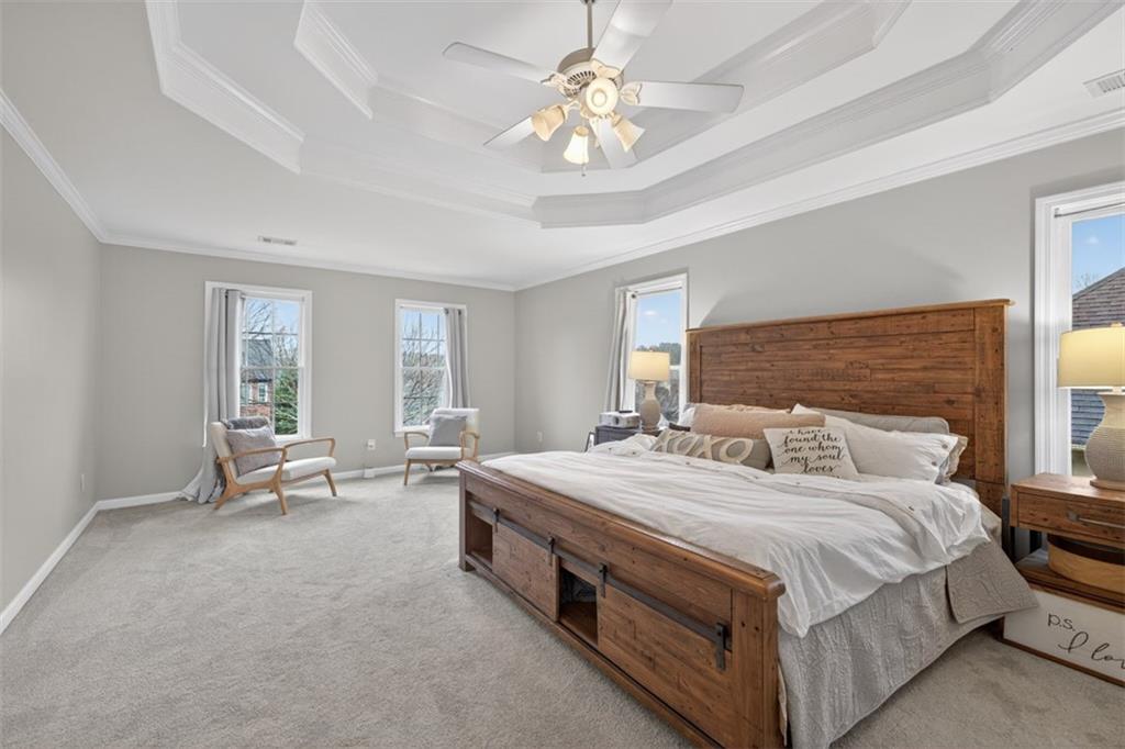 2641 Hillgrove Drive Dacula, GA 30019 - Photo 27 of 57 a bedroom with a bed and a chandelier