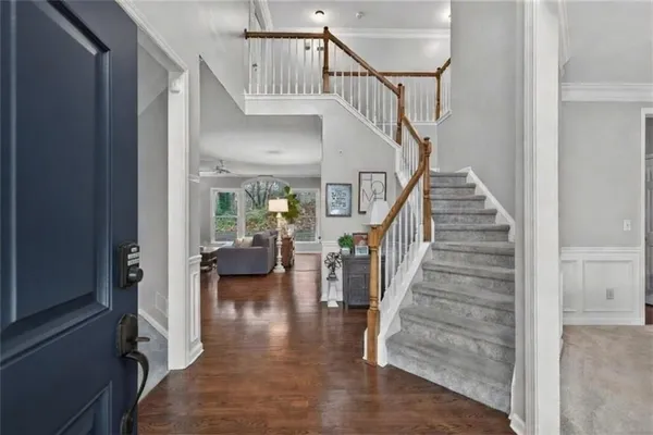 a view of entryway and hall with wooden floor