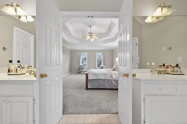 a bedroom with furniture and a large window