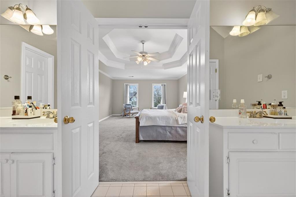 2641 Hillgrove Drive Dacula, GA 30019 - Photo 33 of 57 a spacious bedroom with a bed and a chandelier