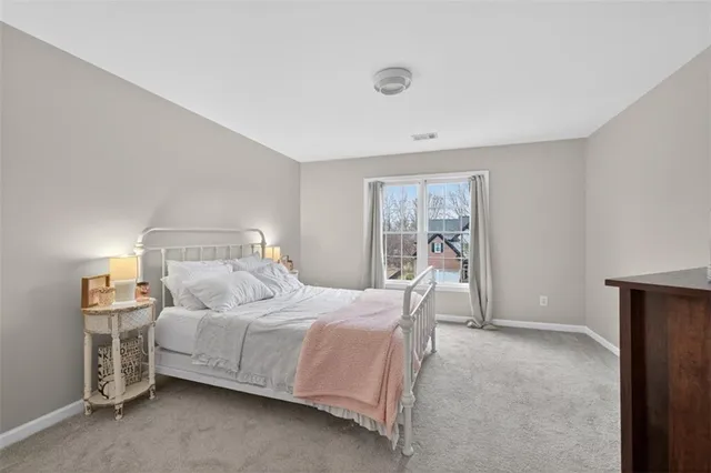 a bedroom with furniture and a large window