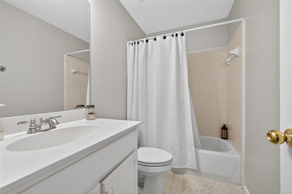 2641 Hillgrove Drive Dacula, GA 30019 - Photo 36 of 57 a bathroom with a sink a toilet and shower curtain