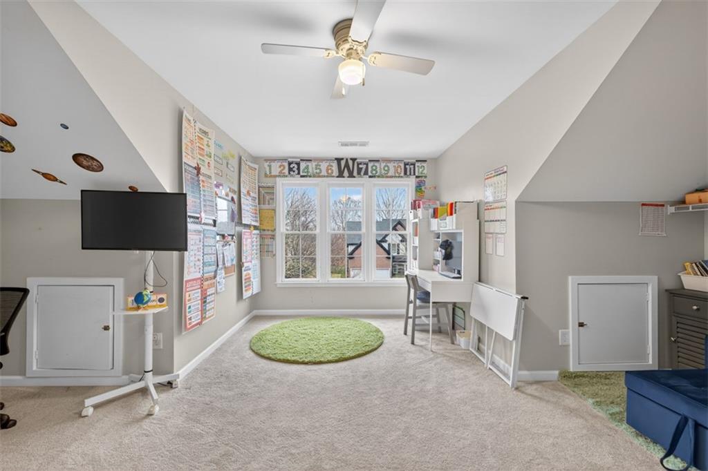 2641 Hillgrove Drive Dacula, GA 30019 - Photo 37 of 57 a view of a livingroom with furniture a flat screen tv and a refrigerator