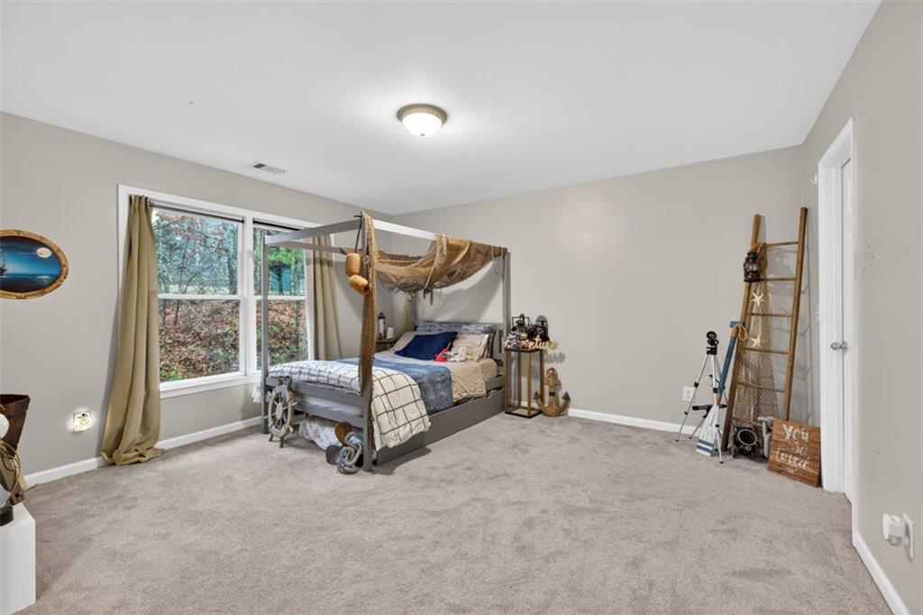 2641 Hillgrove Drive Dacula, GA 30019 - Photo 39 of 57 a bedroom with furniture and a large window