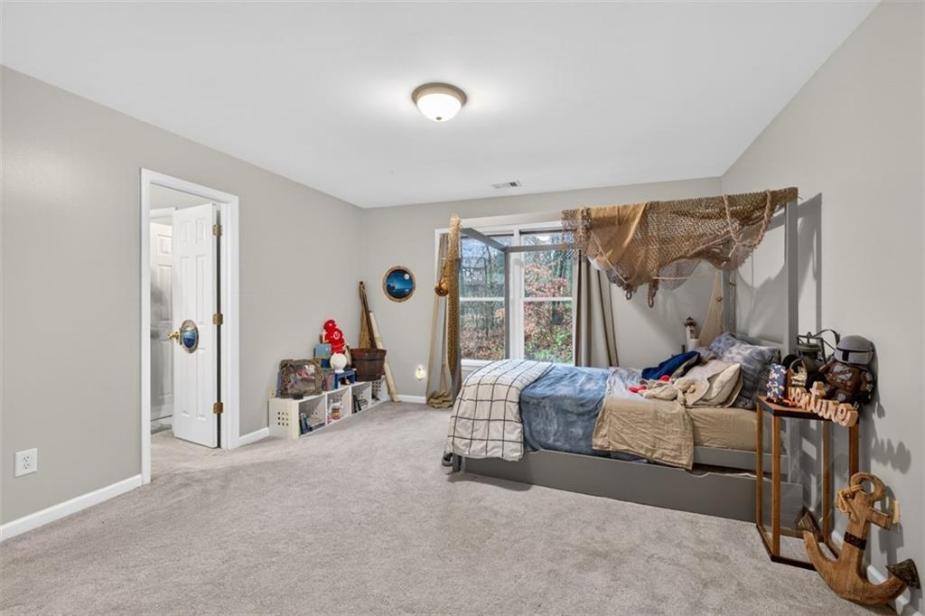 2641 Hillgrove Drive Dacula, GA 30019 - Photo 40 of 57 a bedroom with furniture and a large window