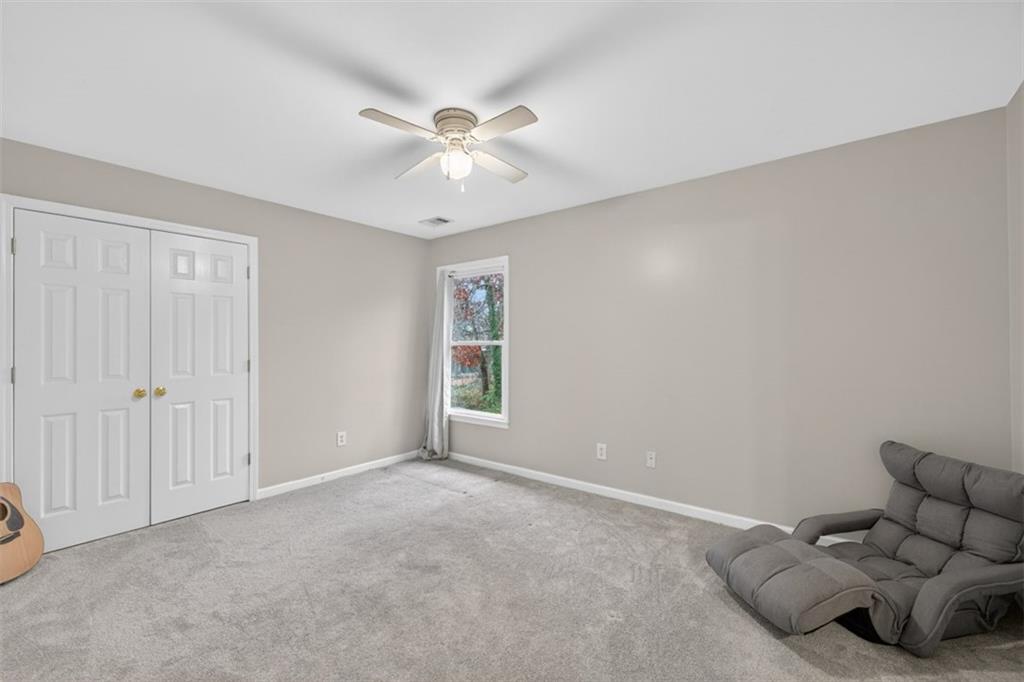 2641 Hillgrove Drive Dacula, GA 30019 - Photo 42 of 57 an empty room with windows and fan