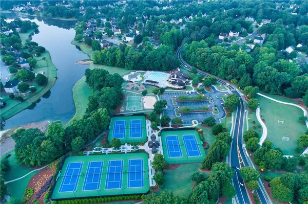 a view of a swimming pool with a patio and a yard