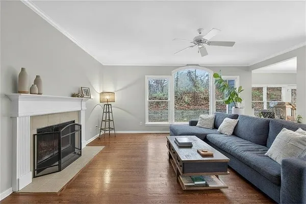 a kitchen with stainless steel appliances granite countertop a refrigerator a stove top oven and a wooden floors