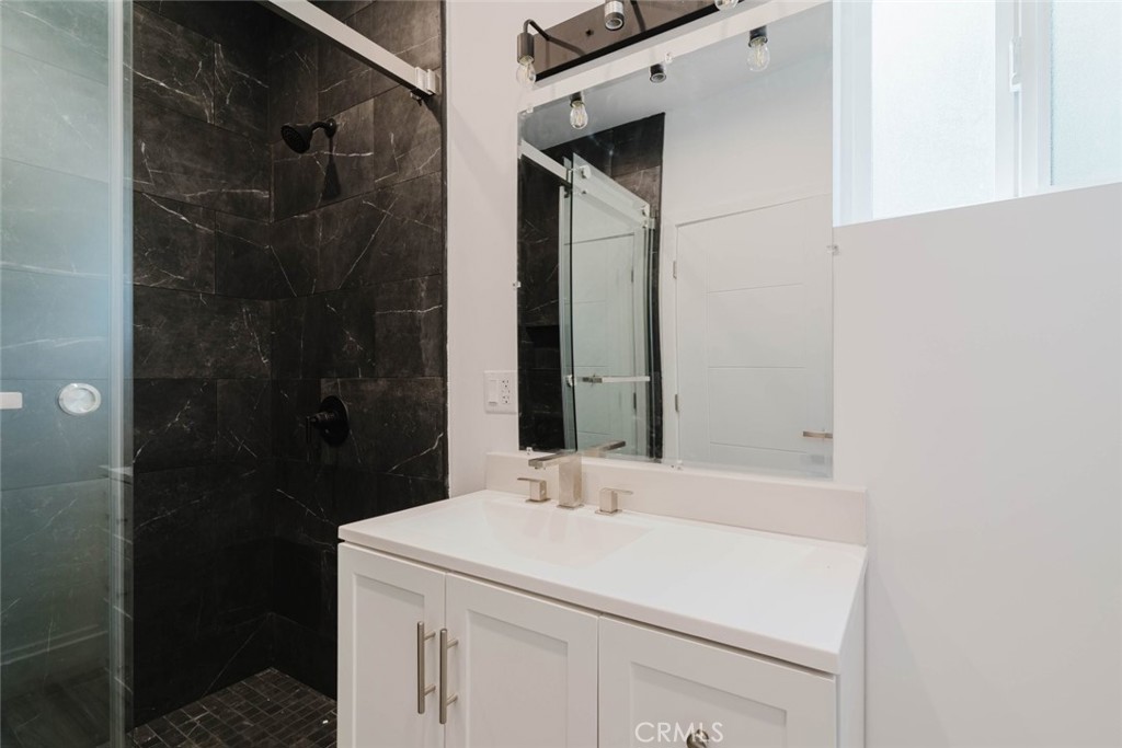 17846 Rinaldi Street Granada Hills, CA 91344 - Photo 24 of 34 a bathroom with a sink and a mirror