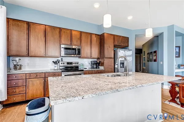 a dining room with stainless steel appliances granite countertop a dining table and chairs