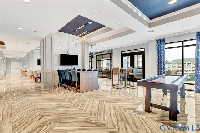 a view of a dining room with furniture a rug and wooden floor