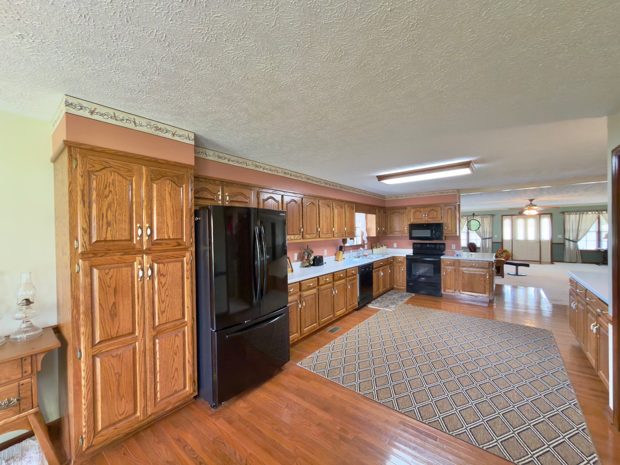 4929 Fountain Grove Road Morrison, TN 37357 - Photo 18 of 33 a kitchen with stainless steel appliances wooden floor and large windows