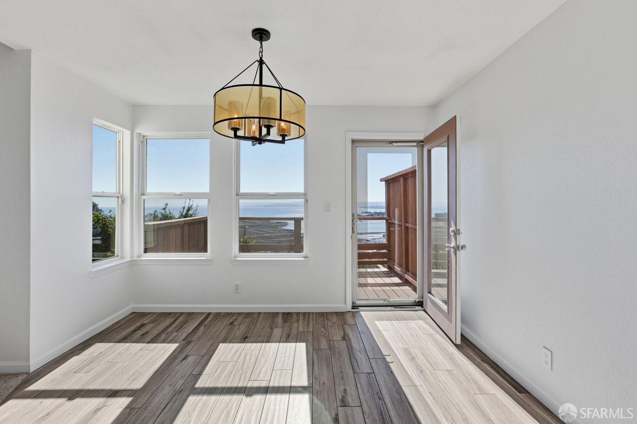 59 Kiska Road San Francisco, CA 94124 - Photo 16 of 46 a view of a hallway with wooden floor and dining table