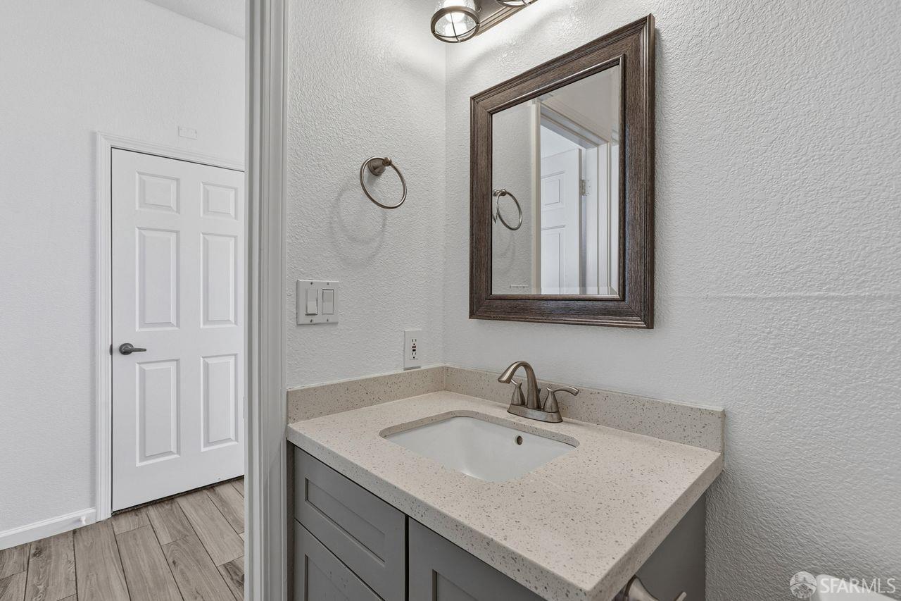 59 Kiska Road San Francisco, CA 94124 - Photo 26 of 46 a bathroom with a sink and a mirror